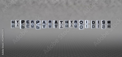 hyperparathyroidism word or concept represented by black and white letter cubes on a grey horizon background stretching to infinity photo