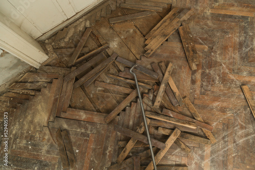 Home improvement. Removing old wooden parquet flooring using crowbar tool. Old wooden floor renovation. 