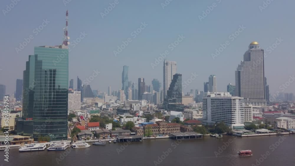 Slowmotion view of Chao phraya river in bangkok with bangkok higrise building on the river bank Slowmotion view of Chao phraya river in bangkok with bangkok higrise building on the river bank