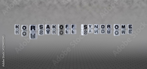 korsakoff syndrome word or concept represented by black and white letter cubes on a grey horizon background stretching to infinity photo