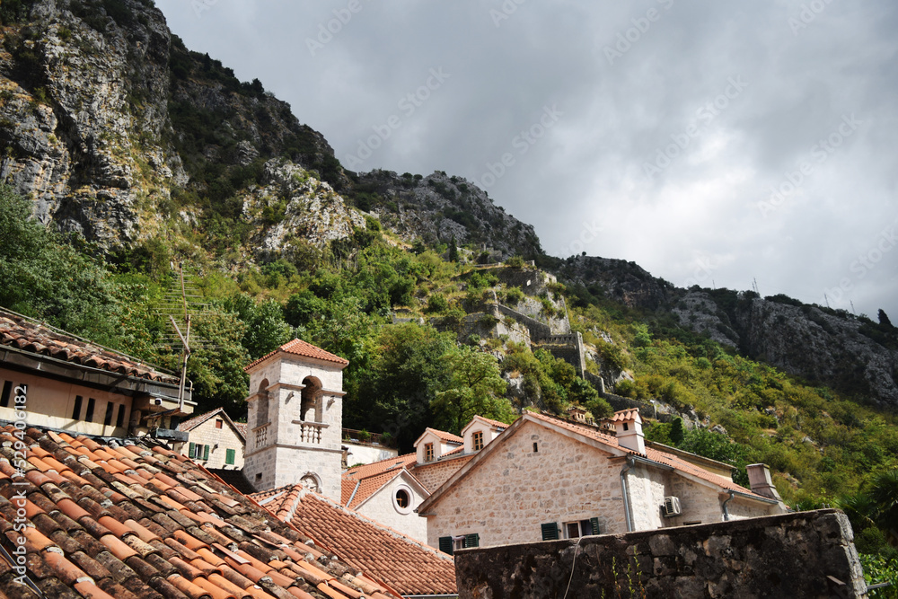 roofs of houses and high mountains in Kotor, Montenegro roofs of houses and high mountains in Kotor, Montenegro