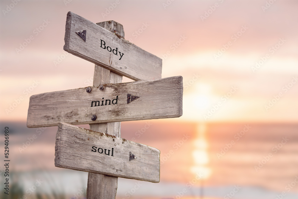 body mind soul text quote engraved on wooden signpost outdoors on the beach with sunset theme. - obrazy, fototapety, plakaty 