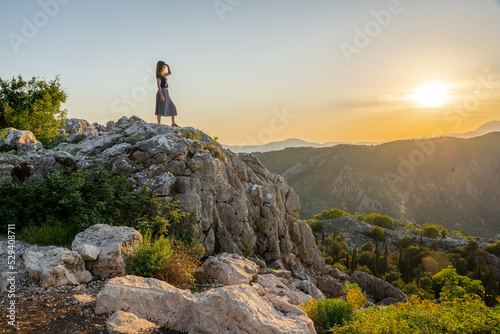A woman overlooking the bay of Kotor, Montenegro mountains