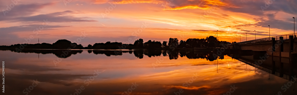 Fototapeta premium Beautiful sunset view with reflections near Plattling, Isar, Bavaria, Germany