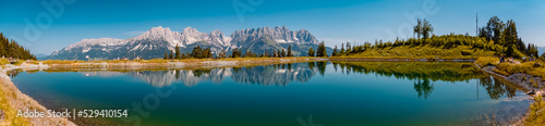 High resolution panorama with reflections in a lake at the famous Astberg summit, Going, Wilder Kaiser, Tyrol, Austria