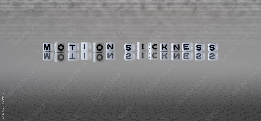 motion sickness word or concept represented by black and white letter cubes on a grey horizon background stretching to infinity - obrazy, fototapety, plakaty 