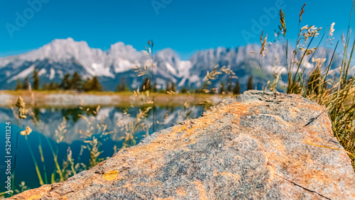 Beautiful alpine summer view with details of a rock at the famous Astberg summit, Going, Wilder Kaiser, Tyrol, Austria photo