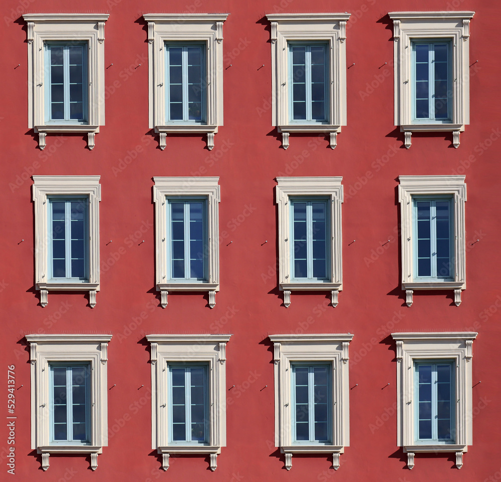 Typical facade in the south of France, on the French Riviera, windows with colored shutters