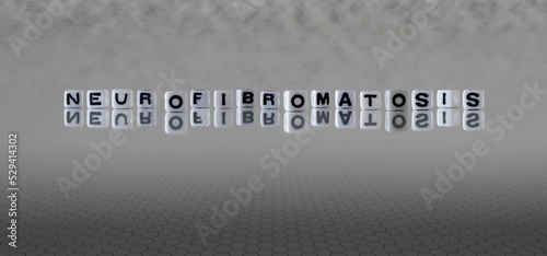 neurofibromatosis word or concept represented by black and white letter cubes on a grey horizon background stretching to infinity photo