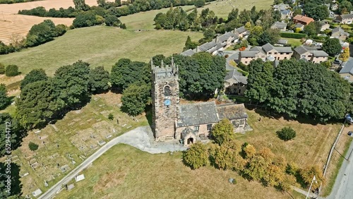 Drone Aerial footage the Emley Village St Michael the Archangel Church in West Yorkshire England. High on Emley Moor. photo