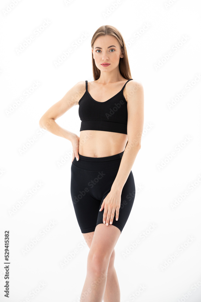 Slim sporty fitness young woman in black sportswear posing Slim sporty fitness young woman in black sportswear posing