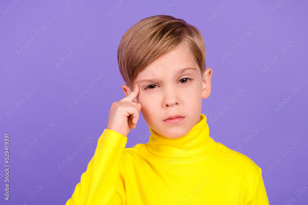 Photo of minded creative pupil finger touch temple ponder contemplate isolated on violet color background Photo of minded creative pupil finger touch temple ponder contemplate isolated on violet color background