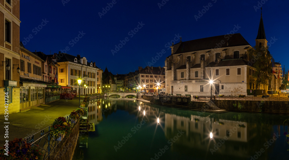 ANNECY, FRANCE - JULY 11, 2022: The old town at dusk with the church Saint Fracois de Sales.