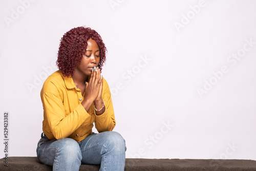 young african lady saying her prayers © Confidence