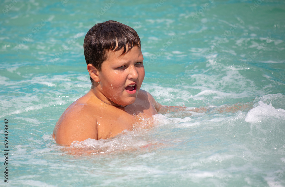 The boy swims in sea water.