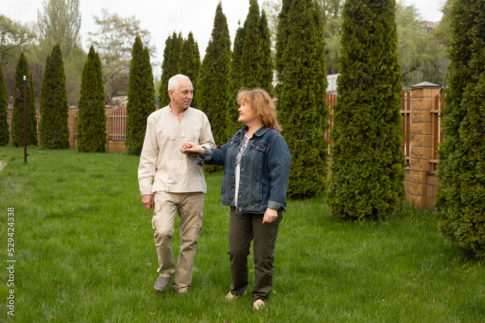 Elderly couple embracing in autumn or summer park Elderly couple embracing in autumn or summer park