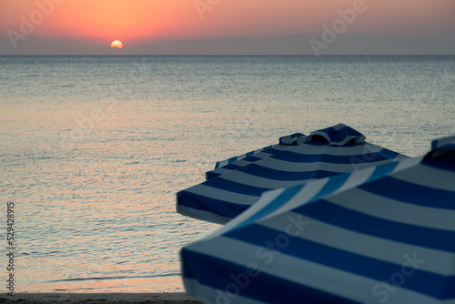 Parasol at sunrise by ocean