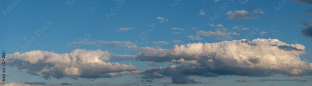 Banner with panoramic view over deep blue clean sky with illuminated clouds as a background. Banner with panoramic view over deep blue clean sky with illuminated clouds as a background.