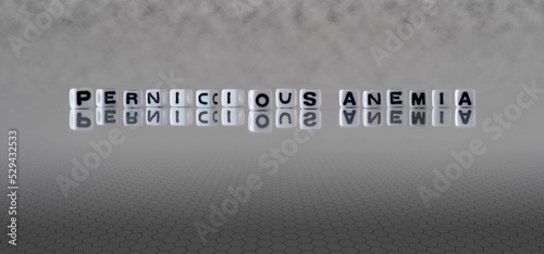 pernicious anemia word or concept represented by black and white letter cubes on a grey horizon background stretching to infinity