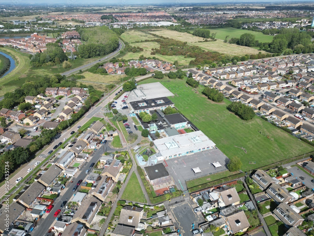aerial view of urban housing estate and community and st Andrews primary school Sutton Park Kingston upon Hull, Yorkshire 