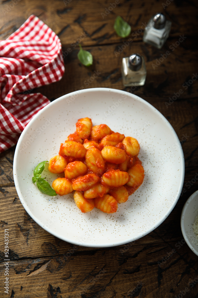Traditional homemade potato gnocchi with tomato sauce Traditional homemade potato gnocchi with tomato sauce
