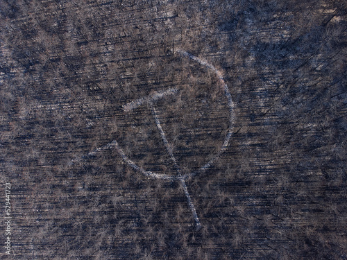 Stone Made Hammer and Sickle on Burned Ground