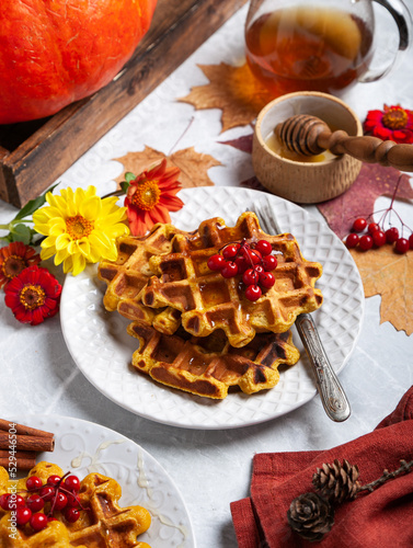 pumpkin waffles on a bright autumn table. autumn, halloween, holidays, holiday, halloween food, healthy food, organic food, farm products, autumn menu, concept.