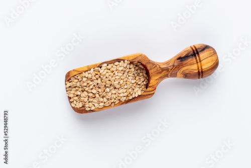 Bio natural sesame seeds on wooden bowl.