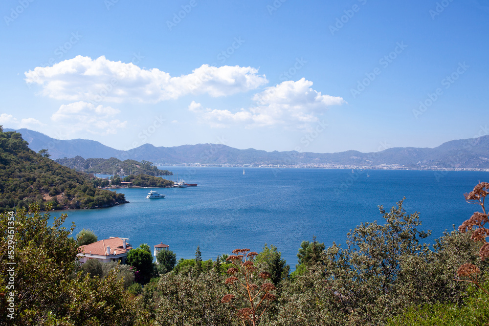 Landscape view of sea bay in Turkey from above. Seascape with blue sea water and mountains with green trees.