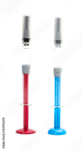 Medical syringe for liquid 1 ml. Red, blue medical syringe with a cap, isolated on a white background.