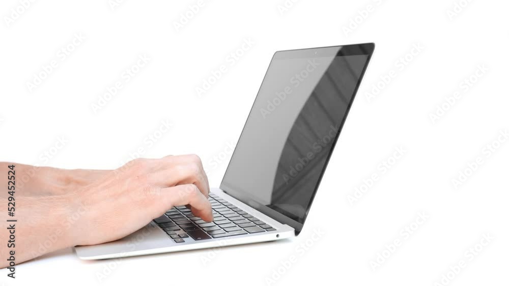 a businessman working in an office with large windows. a businessman working in an office with large windows.