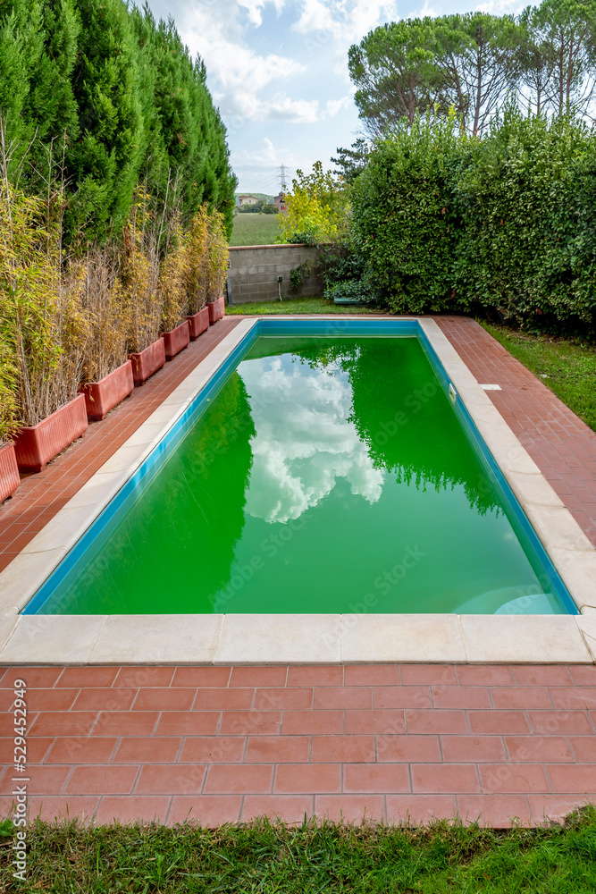 Pool with cloudy green water due to the presence of algae and dirt