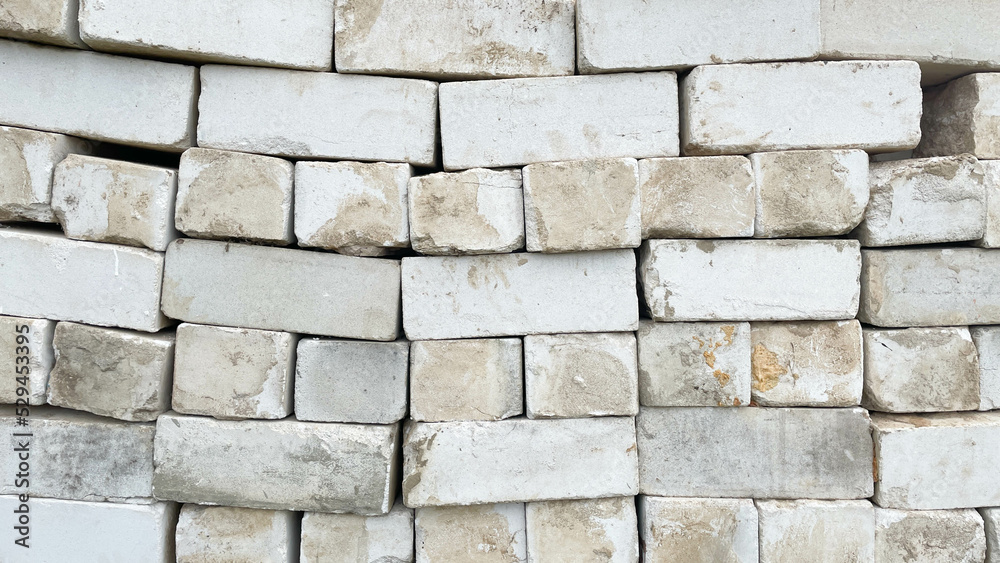 Fototapeta premium Background of old vintage dirty brick wall with peeling plaster, texture.