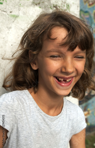 laughing female child without front tooth