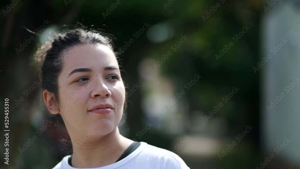 A casual Brazilian girl walking in city street. One pensive 20s woman walks in slow motion outdoors A casual Brazilian girl walking in city street. One pensive 20s woman walks in slow motion outdoors