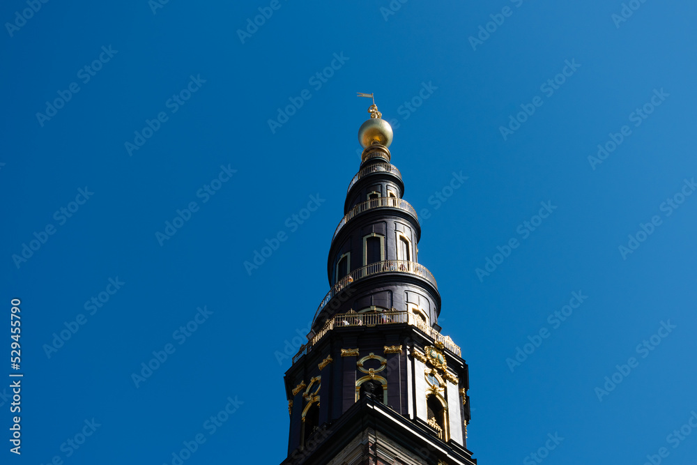 Spiral top of the tower of Church of Our Saviour in Copenhagen, Denmark against the blue sky in summer Spiral top of the tower of Church of Our Saviour in Copenhagen, Denmark against the blue sky in summer