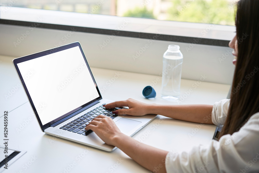 Laptop mockup. Young Asian woman typing on laptop with blank screen Laptop mockup. Young Asian woman typing on laptop with blank screen