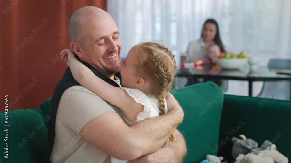 Happy preteen daughter run into fathers arm and kiss