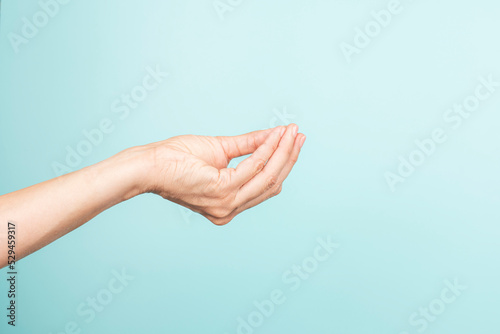 Italian hand gesture. Woman hand Italian gesture on light blue background. Front view, copy space