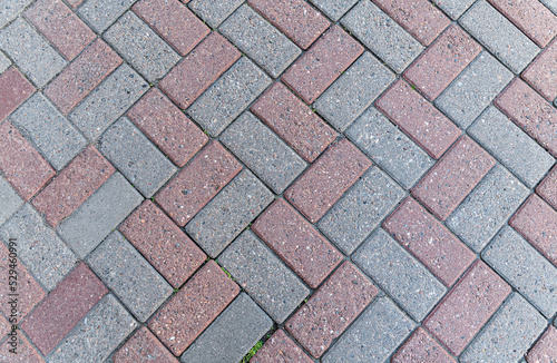 Texture of red-gray street pavers. Road surface.