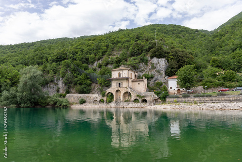 Scanno lake in Abruzzo in Italy in summer with the Church of the Madonna del Lago in the background. photo