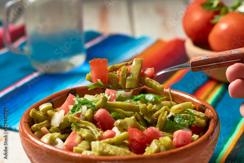 Traditional mexican nopal cactus salad or nopales a la mexicana. Vegan food.