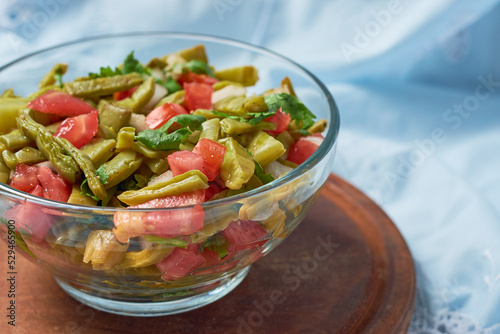 Traditional mexican nopal cactus salad or nopales a la mexicana. Vegan food. photo