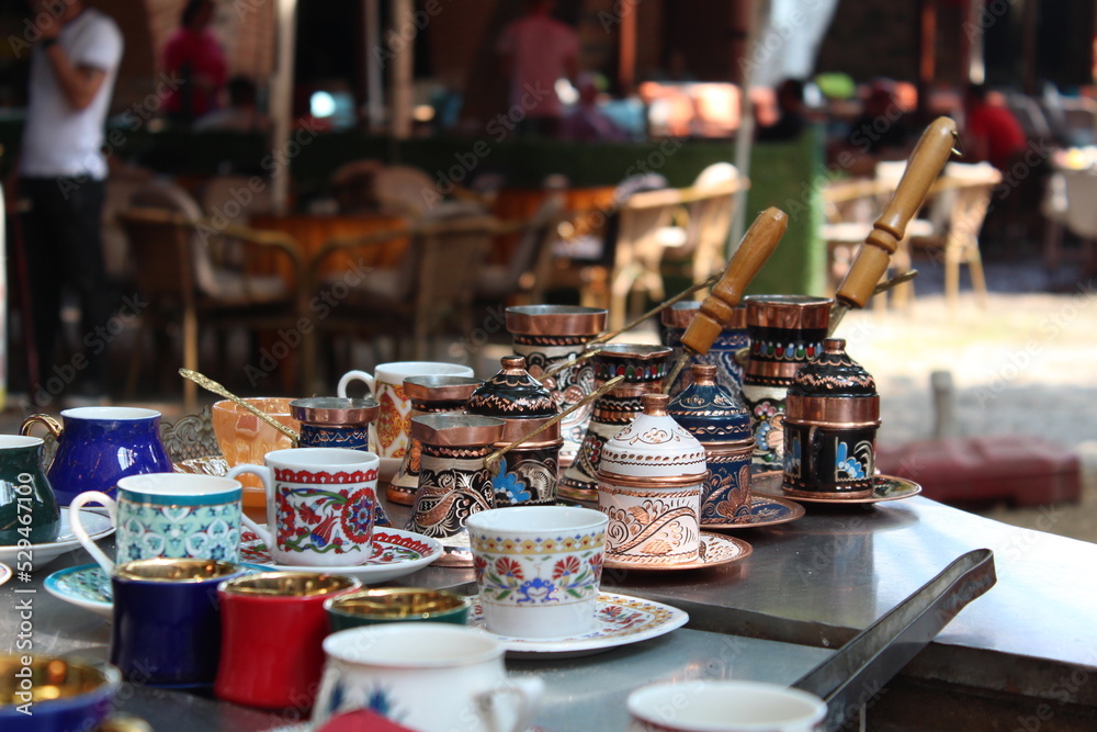 selective focus : turkish coffee cups, turkish coffee cups and coffee pots decorated with local patterns, each more colorful than the other, lined up on the coffee counter in kozahan bursa turkey