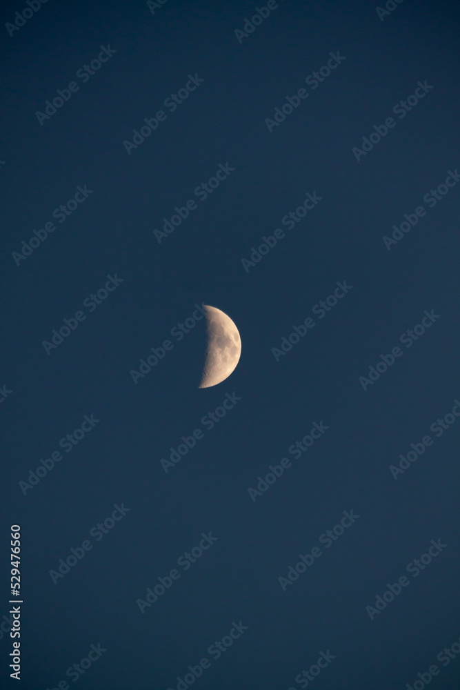 Beautiful macro shot of a large bright mysterious famous celestial body of the earth's satellite of the growing crescent moon on a dark blue sky at midnight Beautiful macro shot of a large bright mysterious famous celestial body of the earth's satellite of the growing crescent moon on a dark blue sky at midnight