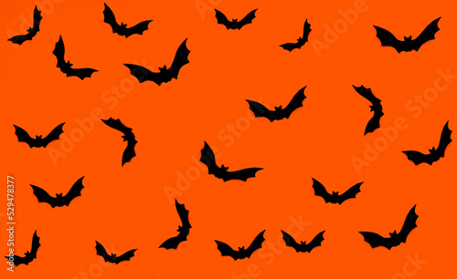 Halloween pattern seamless. Orange background with many black bats. Substrate for text