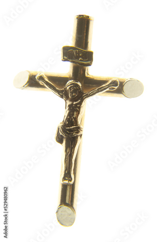 A golden jewel representing Jesus Christ on the cross. Isolated 