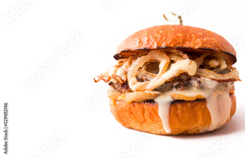 Burger with beef cutlet under tender cream cheese with champignons and onion chips on a white background