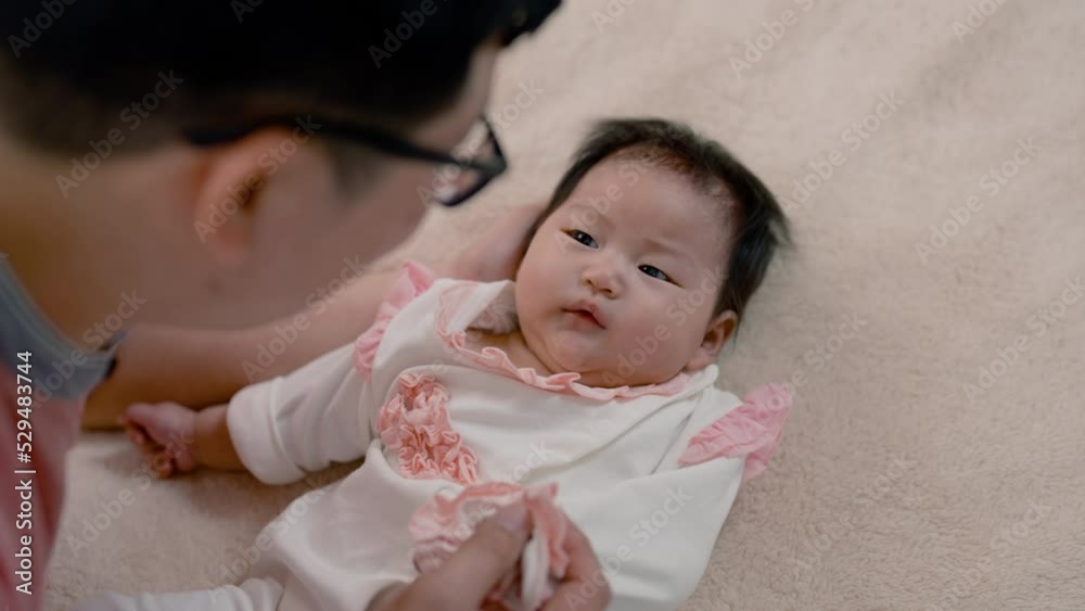 4K, Close-up of Asian baby girl face, lying on a soft brown bed, And the father cherishes the little boy's hand, and sleeps with his daughter warmly, The little boy looked puzzled at his father. 4K, Close-up of Asian baby girl face, lying on a soft brown bed, And the father cherishes the little boy's hand, and sleeps with his daughter warmly, The little boy looked puzzled at his father.