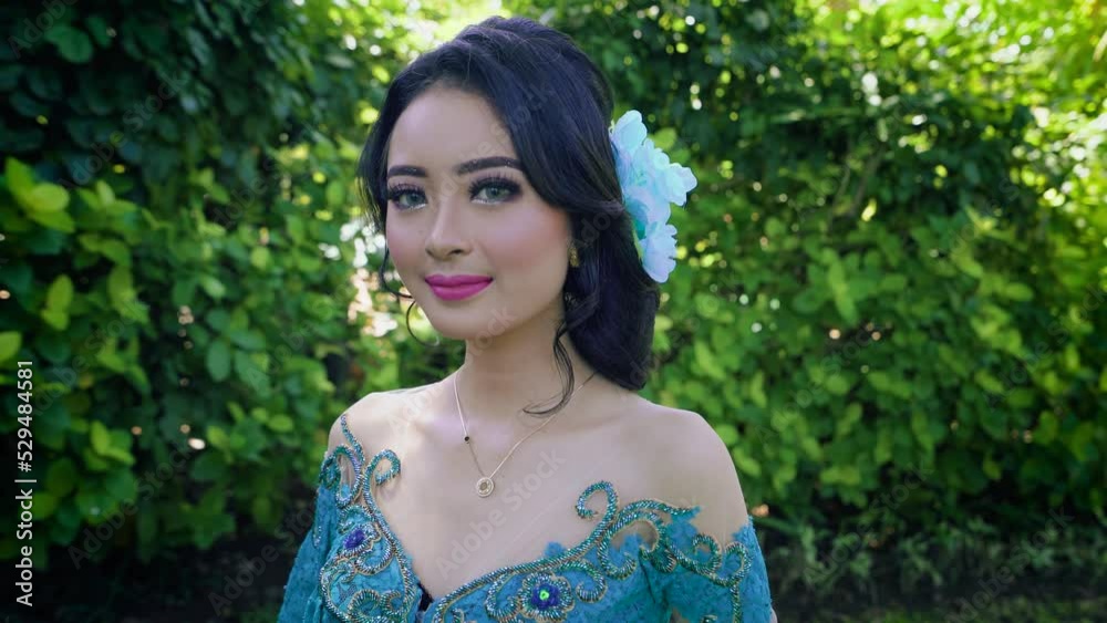 Close-up pretty asian girl with makeup and beautiful hairstyle, wearing holiday dress for graduation day. Shot outdoors 4K Close-up pretty asian girl with makeup and beautiful hairstyle, wearing holiday dress for graduation day. Shot outdoors 4K